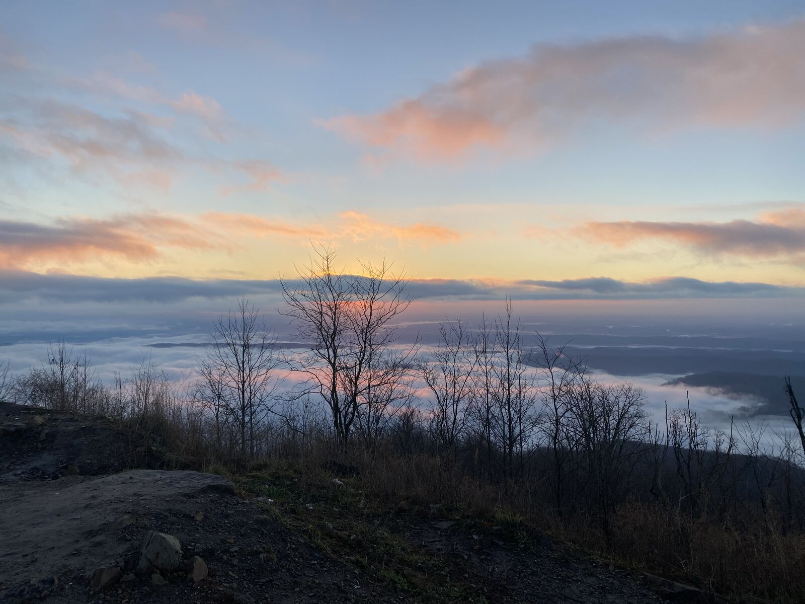 Sunrise above the clouds from a mountain summit