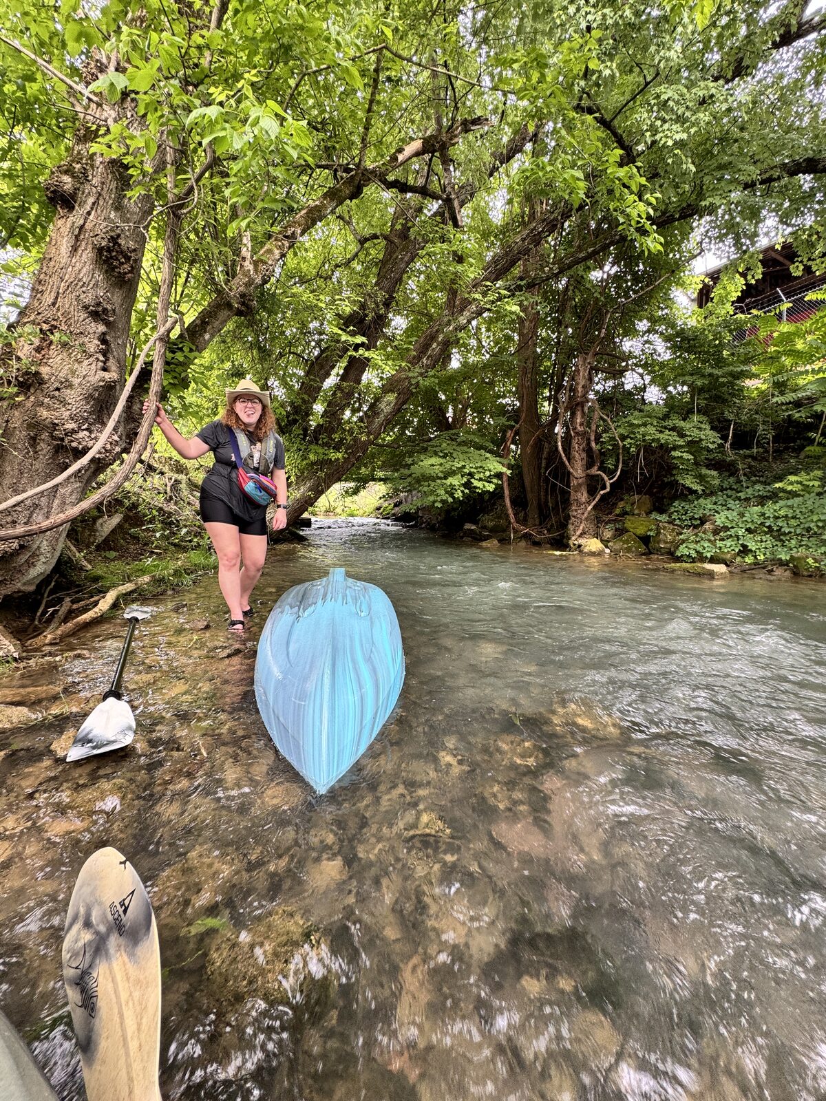 Standing in the creek with an umbrella
